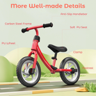 Red balance bike with labeled features on a green landscape background