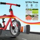 Red balance bike with 12" PU tires on a road surface, featuring durability features.